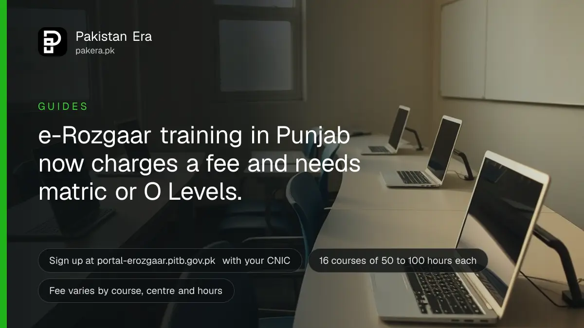 Rows of laptops on long desks in an empty computer training room with afternoon light