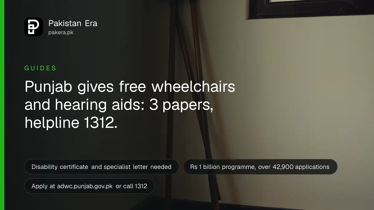 Empty folding wheelchair on a clean ward floor beside a plain cream wall in soft light