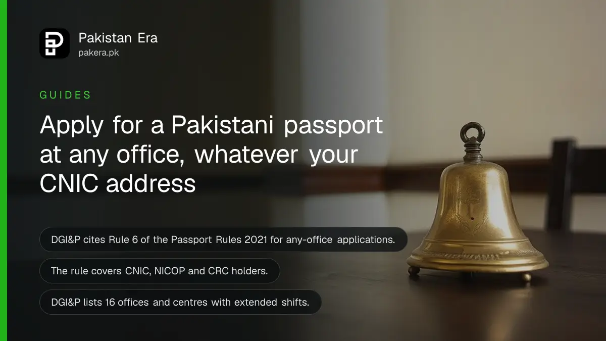 A brass bell on a dark wooden table, for a guide to applying for a passport at any office in Pakistan