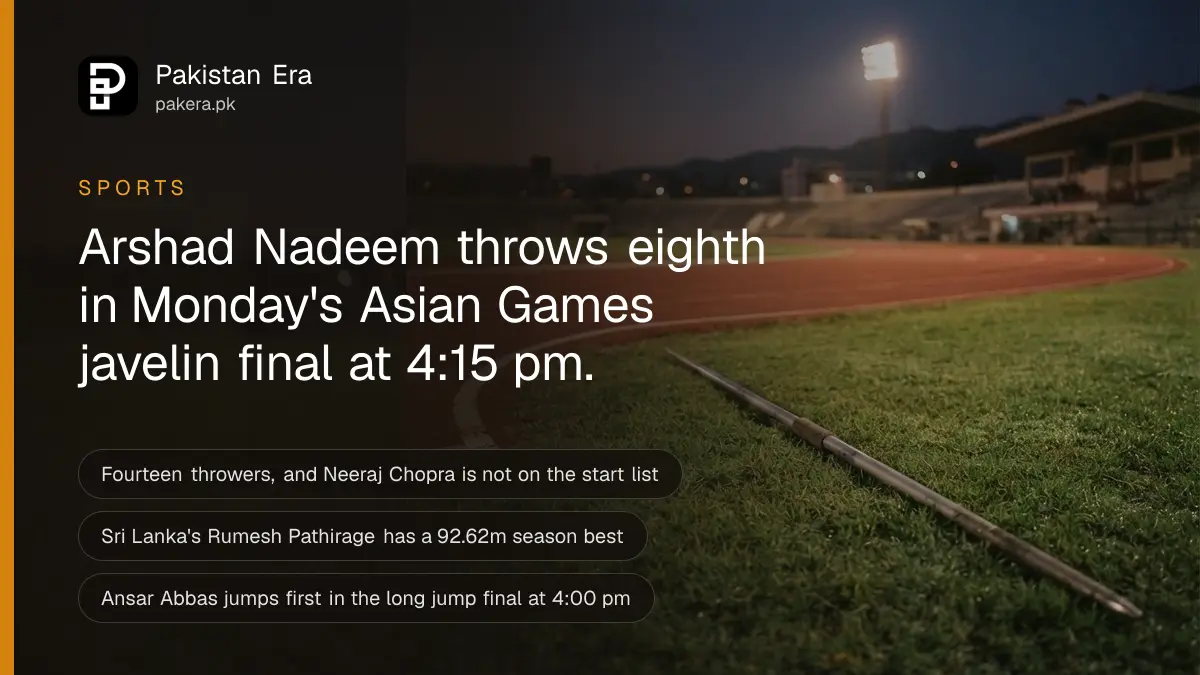 A javelin lying on the green infield grass of an empty athletics stadium at dusk
