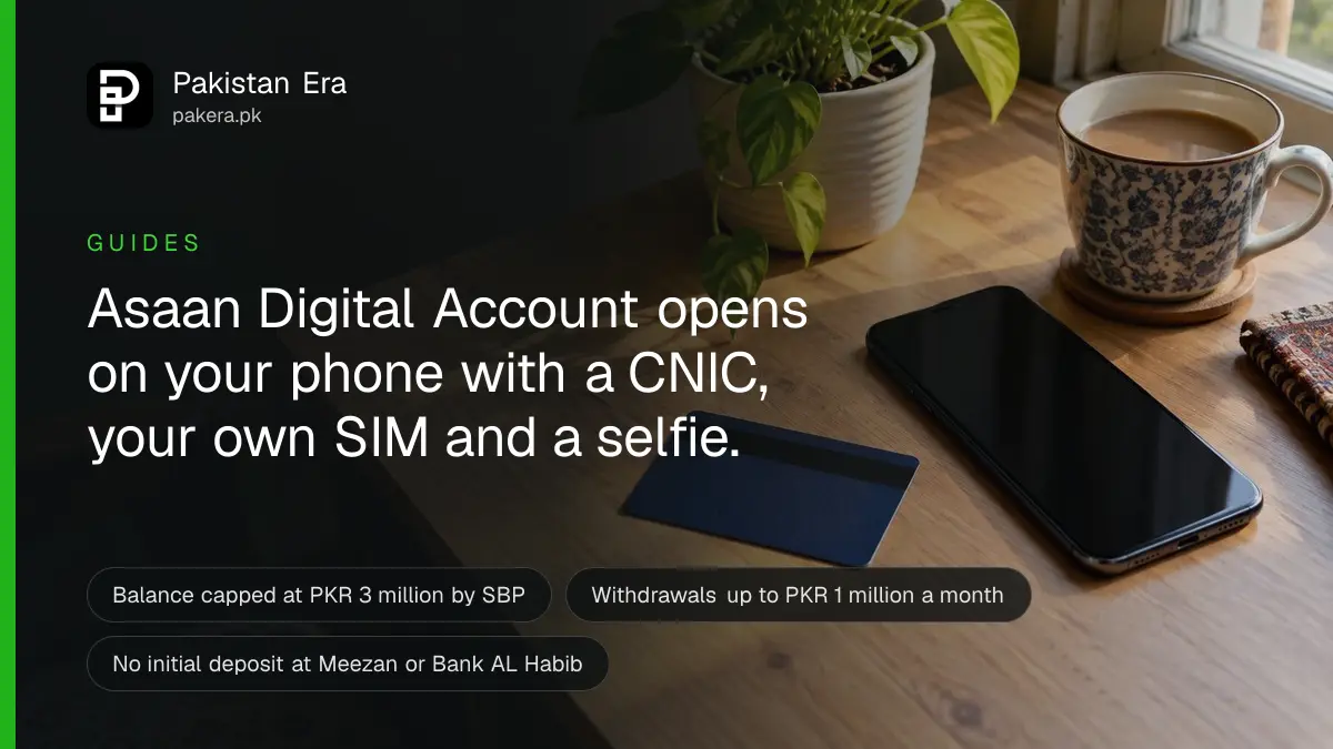 A plain debit card lying face down beside a smartphone with its screen off on a wooden desk