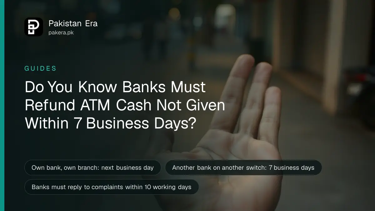 An open empty brown leather wallet held in one hand on a city street at dusk