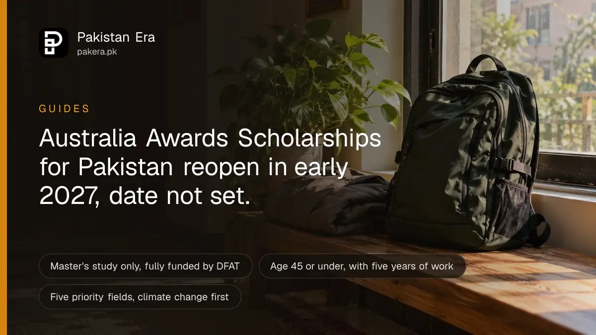 A travel backpack and a folded jacket on a wooden bench by a sunny window