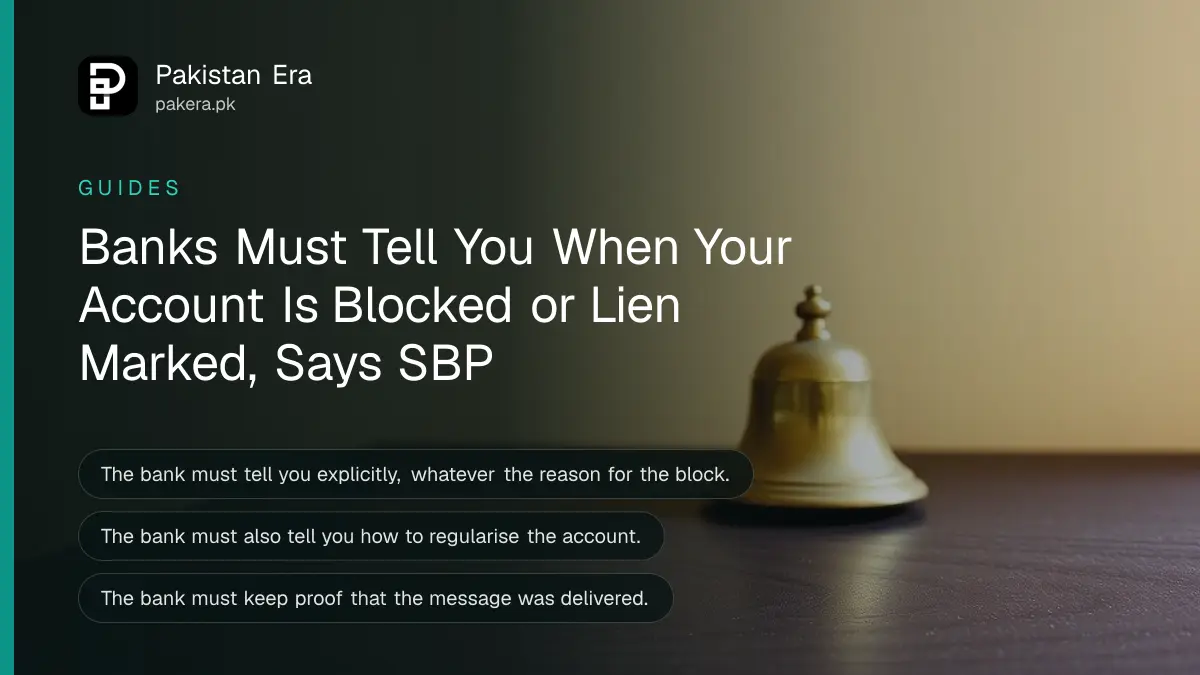 A closed brass bell on a dark wooden table against a plain cream wall for an article on a blocked bank account