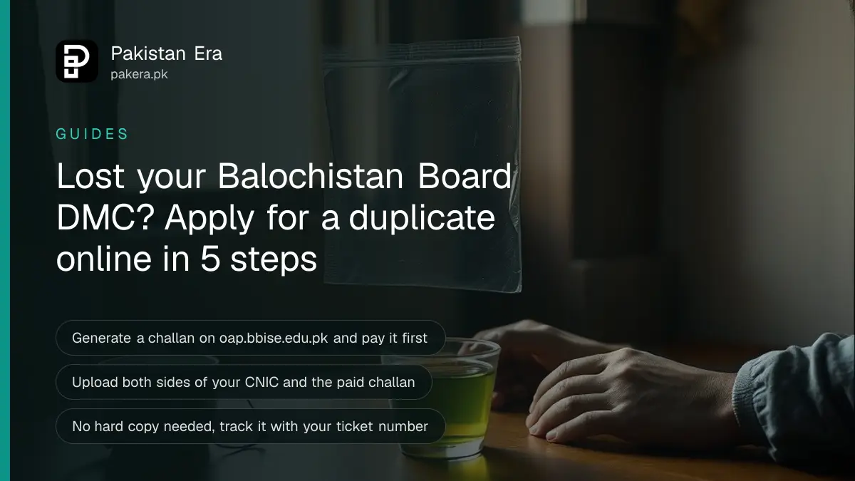 A student's hands holding an empty plastic sleeve at a wooden desk in a Quetta home, with a cup of tea beside it