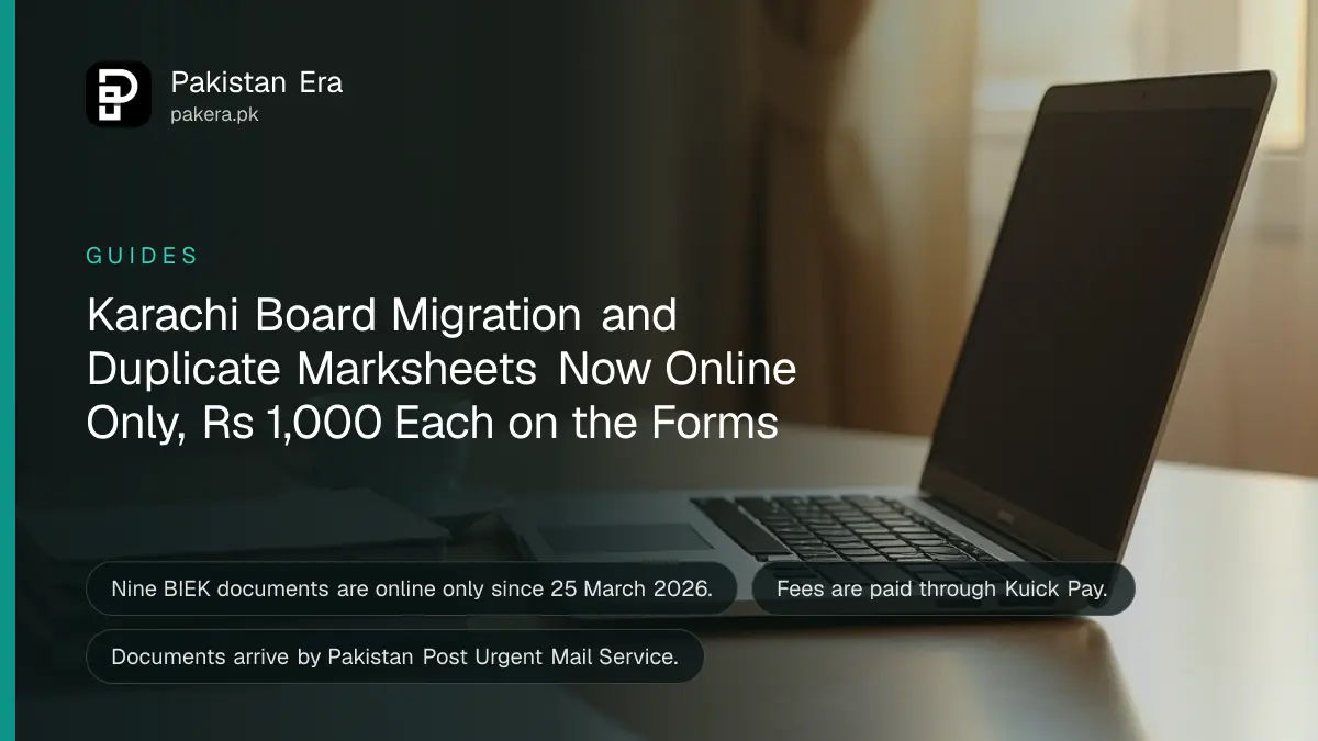An open plain silver laptop on a home table beside a stack of plain notebooks in warm light
