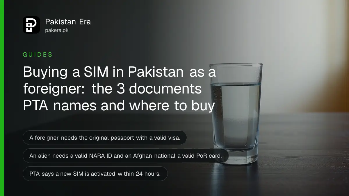 A glass of water on a dark wooden table, for a guide on buying a SIM in Pakistan as a foreigner