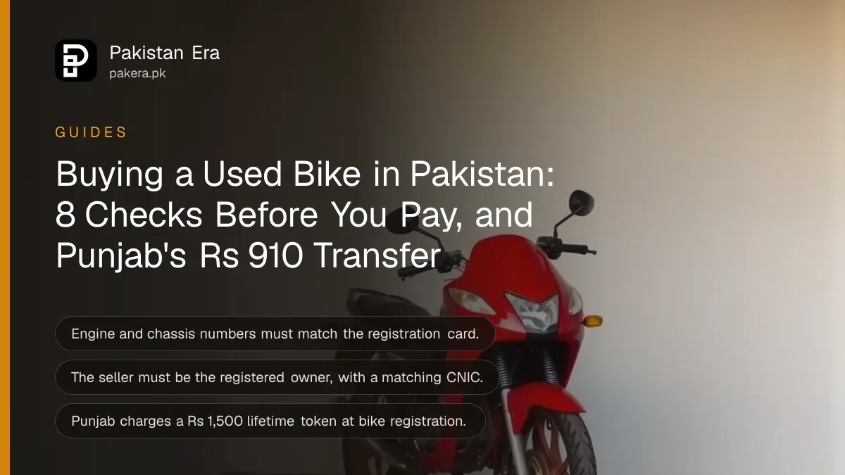 A motorcycle parked against a white wall