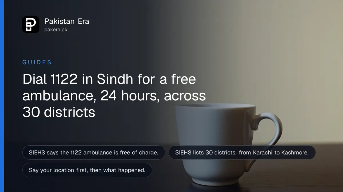 A plain white cup on a dark wooden table against a cream wall, for a guide on calling a free 1122 ambulance in Sindh