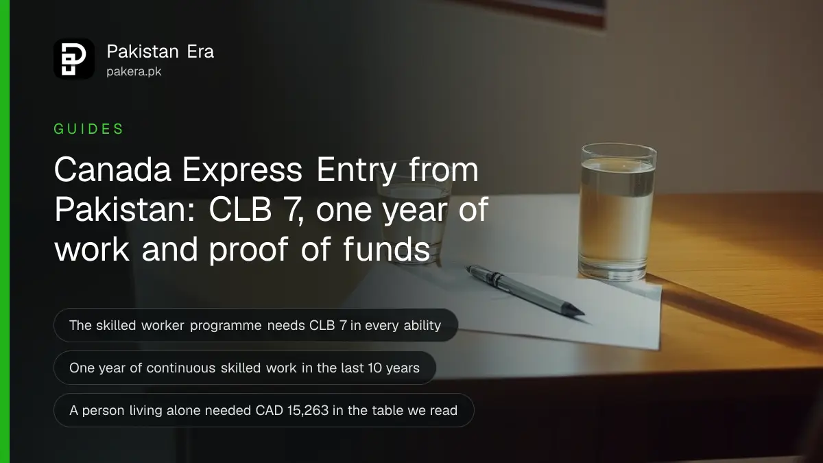 A plain wooden desk with a pen and a glass of water beside a window in a quiet empty room
