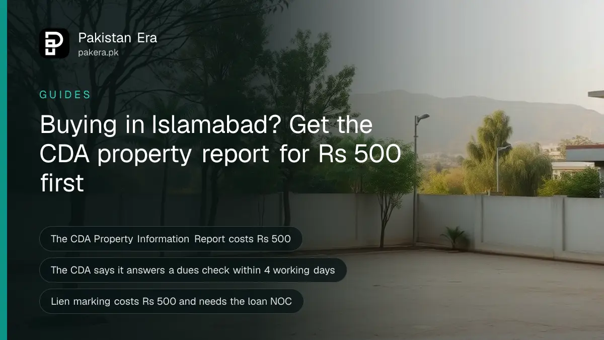 An empty residential plot with a low boundary wall and young trees in Islamabad under a clear sky