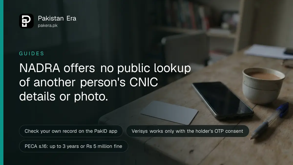 A blank ID-sized card lying face down on a desk next to a smartphone in an Islamabad home office