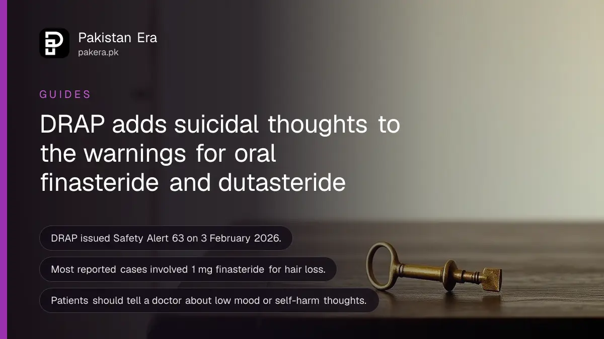 A brass key on a dark wooden table, for a DRAP safety alert on finasteride and dutasteride
