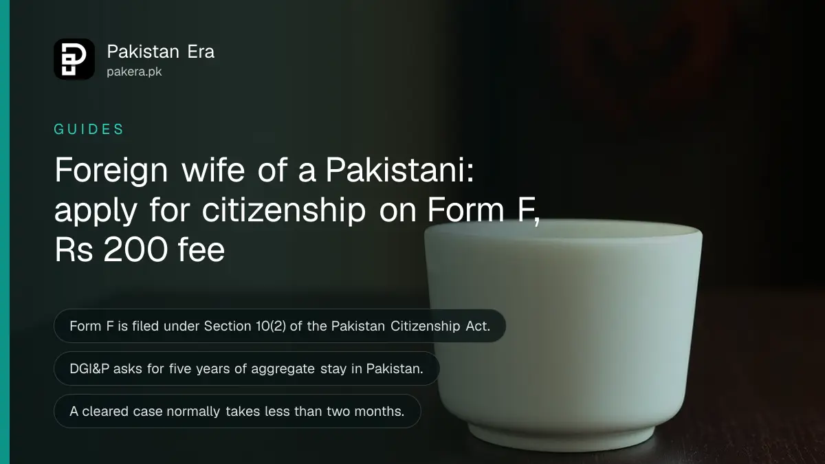 A white ceramic cup on a dark wooden table, for an article on pakistan citizenship foreign wife