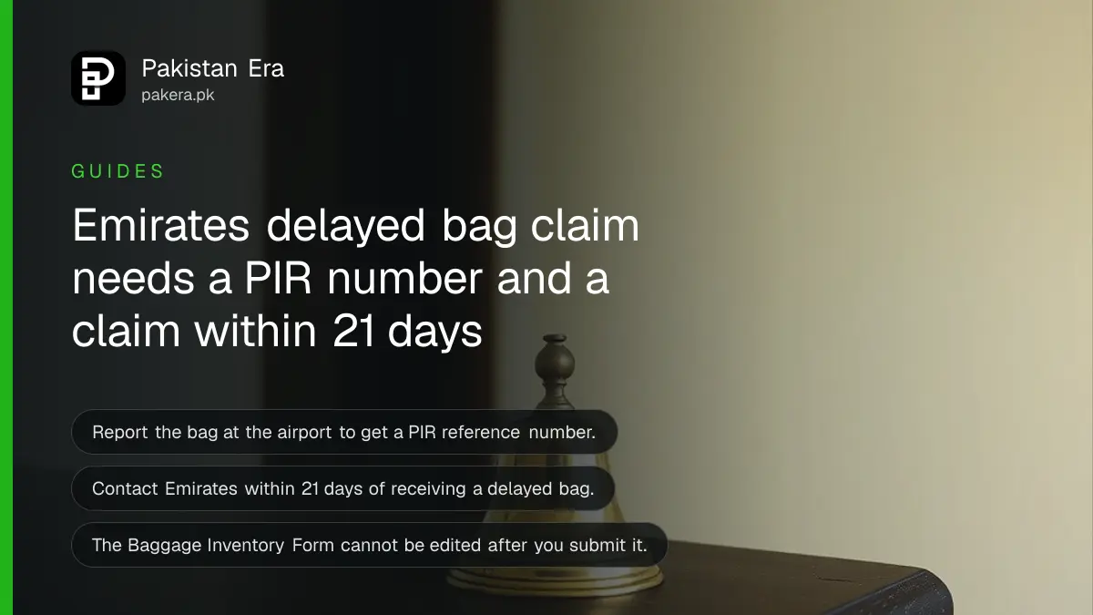 A small brass bell on a dark wooden table, for a guide on claiming delayed baggage with Emirates
