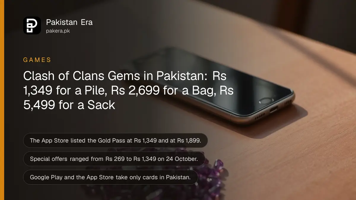 A small pile of polished purple gemstones beside a smartphone lying face up with its screen dark on a wooden table