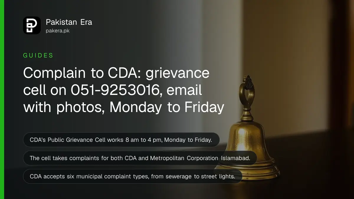 A small brass bell on a dark wooden table, for a guide on complaining to CDA in Islamabad