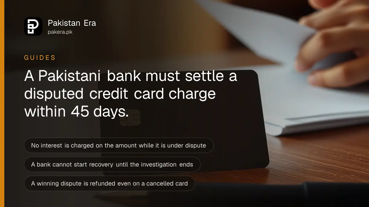A credit card placed face down beside a printed statement and a pen on a desk, no visible numbers or logos