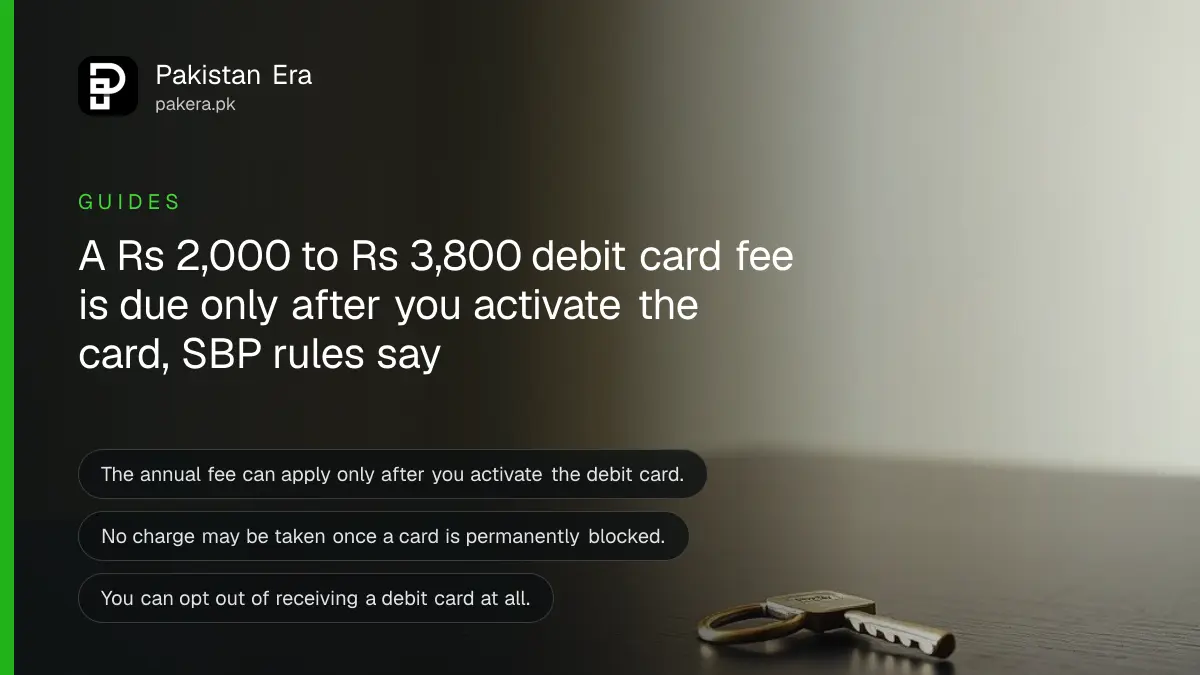 A brass key on a dark wooden table, for an article on debit card fee rules in Pakistan