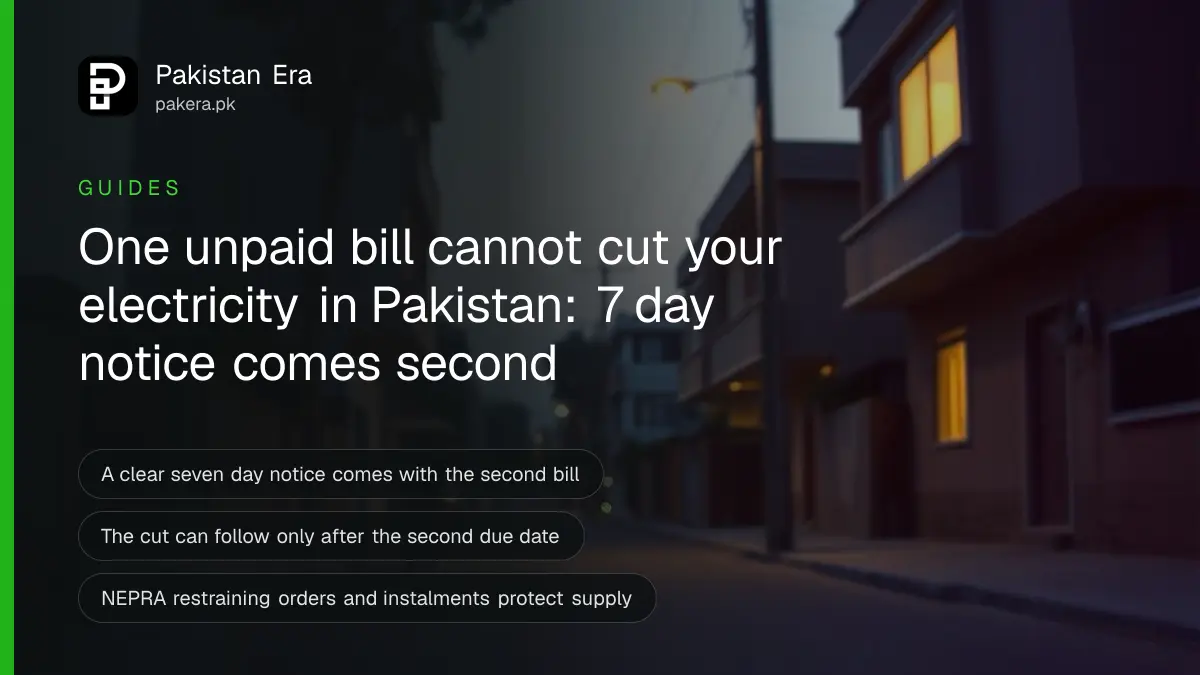 A quiet street at dusk with a single electricity pole and softly lit house windows in a Pakistani neighbourhood