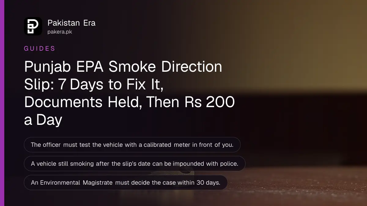 A brass key on a dark wooden table against a plain cream wall in soft daylight, for a vehicle held under Punjab's smoke rules