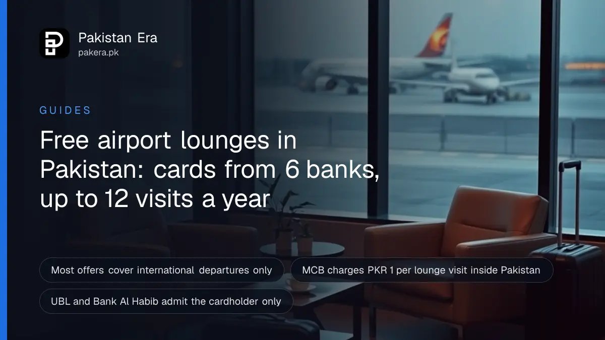 A quiet airport lounge with empty armchairs, a cup of tea and a carry-on bag beside a large window at dusk