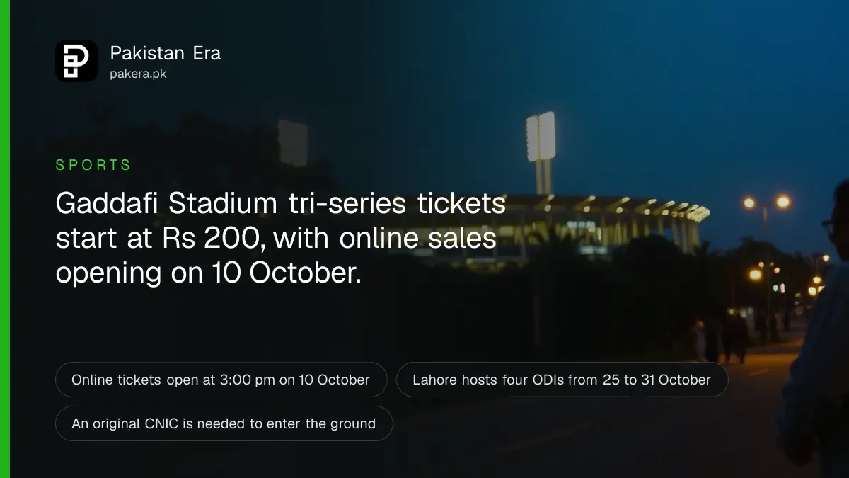 Floodlit Gaddafi Stadium in Lahore at dusk with a tree-lined road and fans walking in the distance