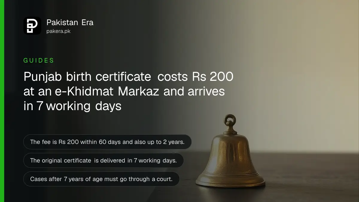 A small brass bell on a dark wooden table, for a guide to getting a birth certificate in Punjab