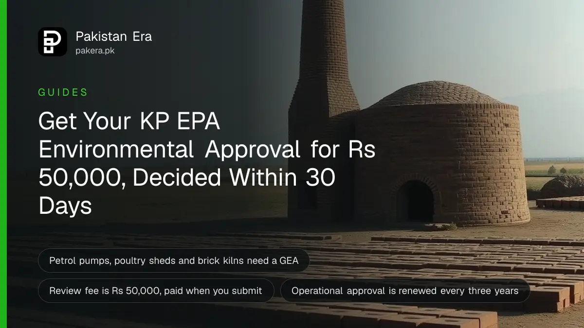 A brick kiln chimney standing in open farmland near Peshawar on a clear morning