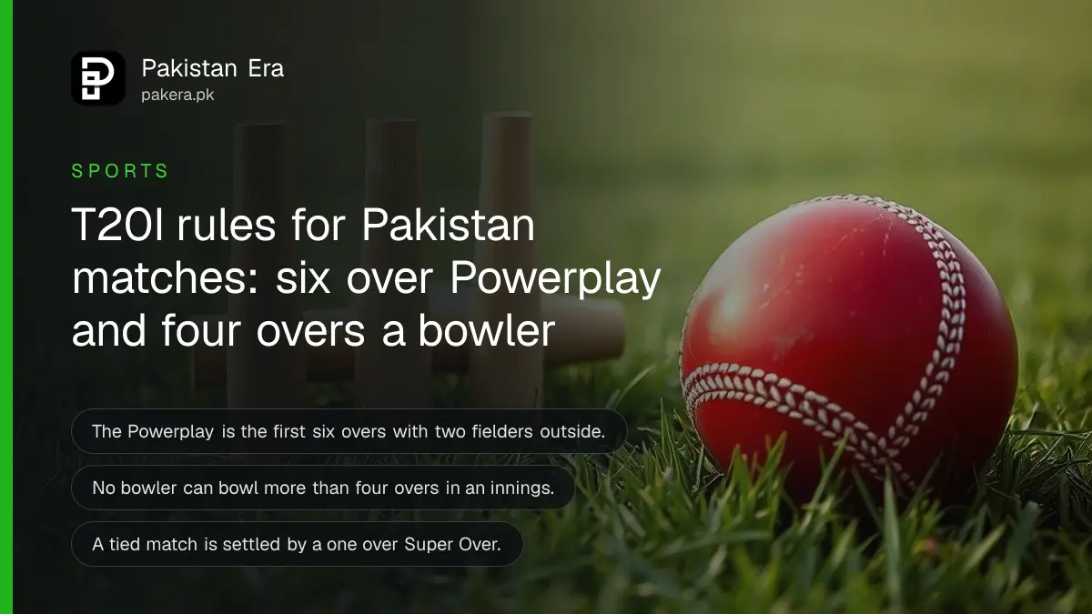 A red cricket ball beside wooden stumps on green grass, for a guide to T20I rules in Pakistan