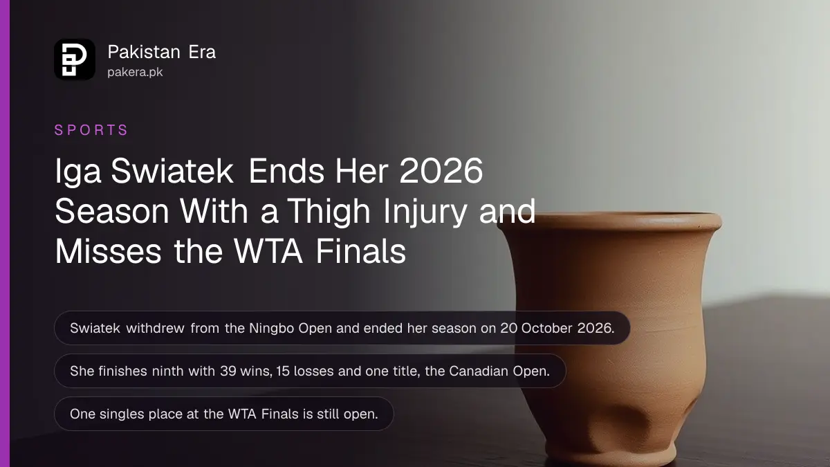 A clay cup on a dark wooden table against a plain cream wall