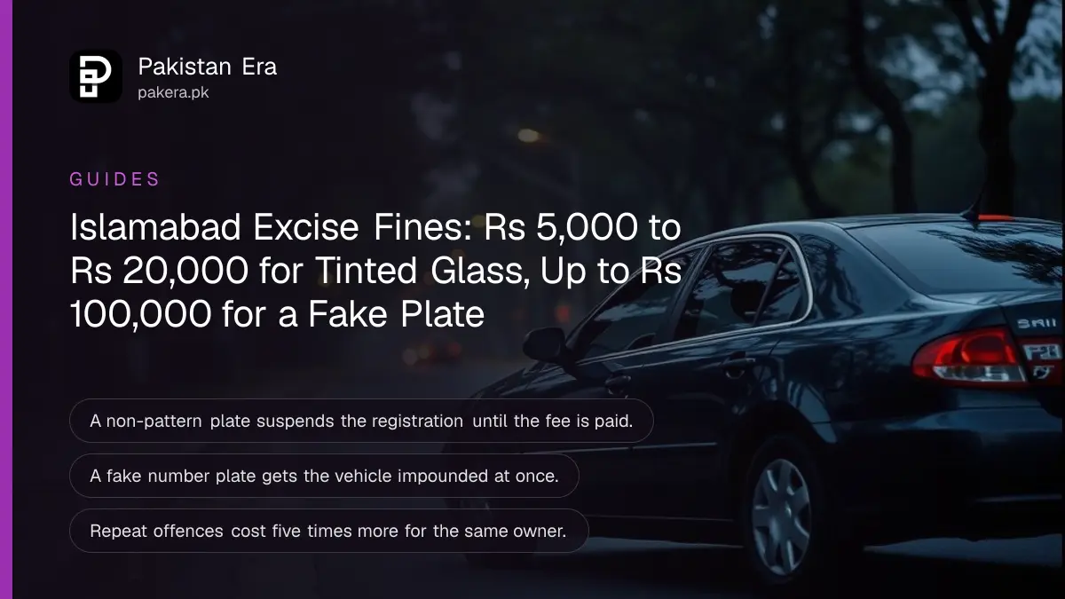 A dark car with darkened windows parked side on along a quiet tree-lined road at dusk