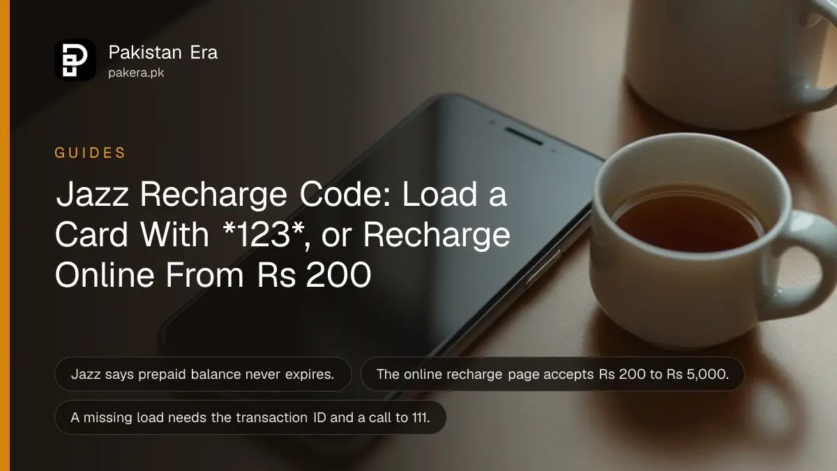 A smartphone lying face up on a wooden desk with its screen dark, a small SIM card tray and a cup of tea beside it in soft morning light