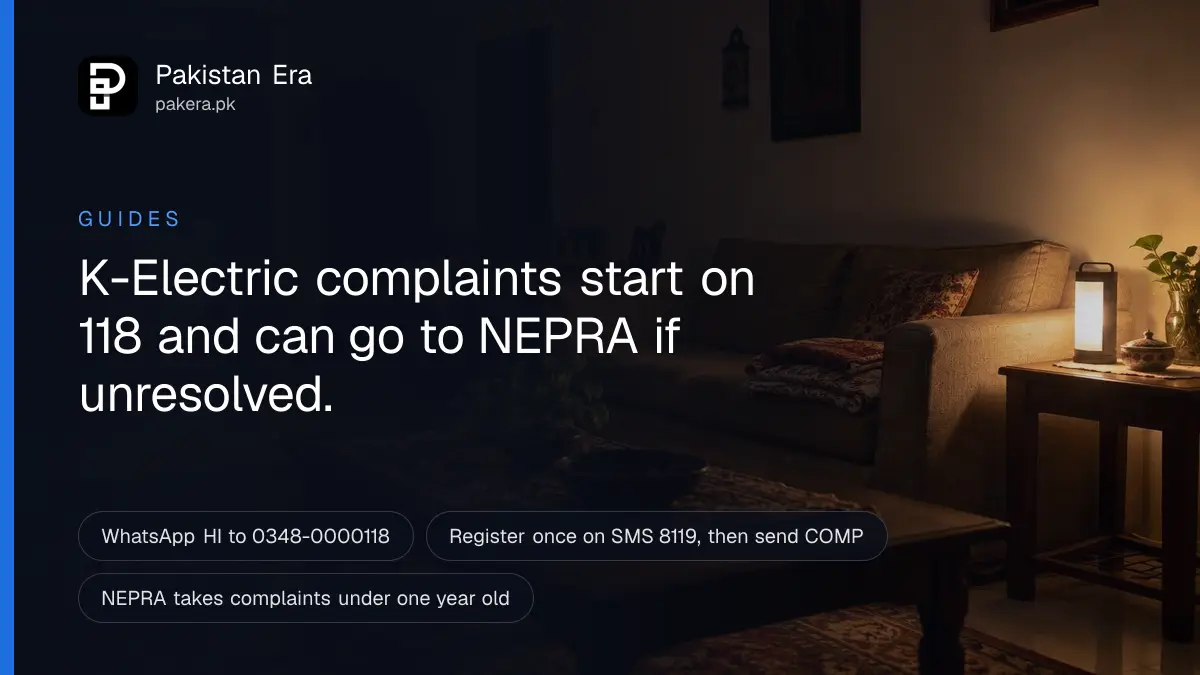 A dim living room in Karachi lit by a single emergency lamp on a side table during a power cut