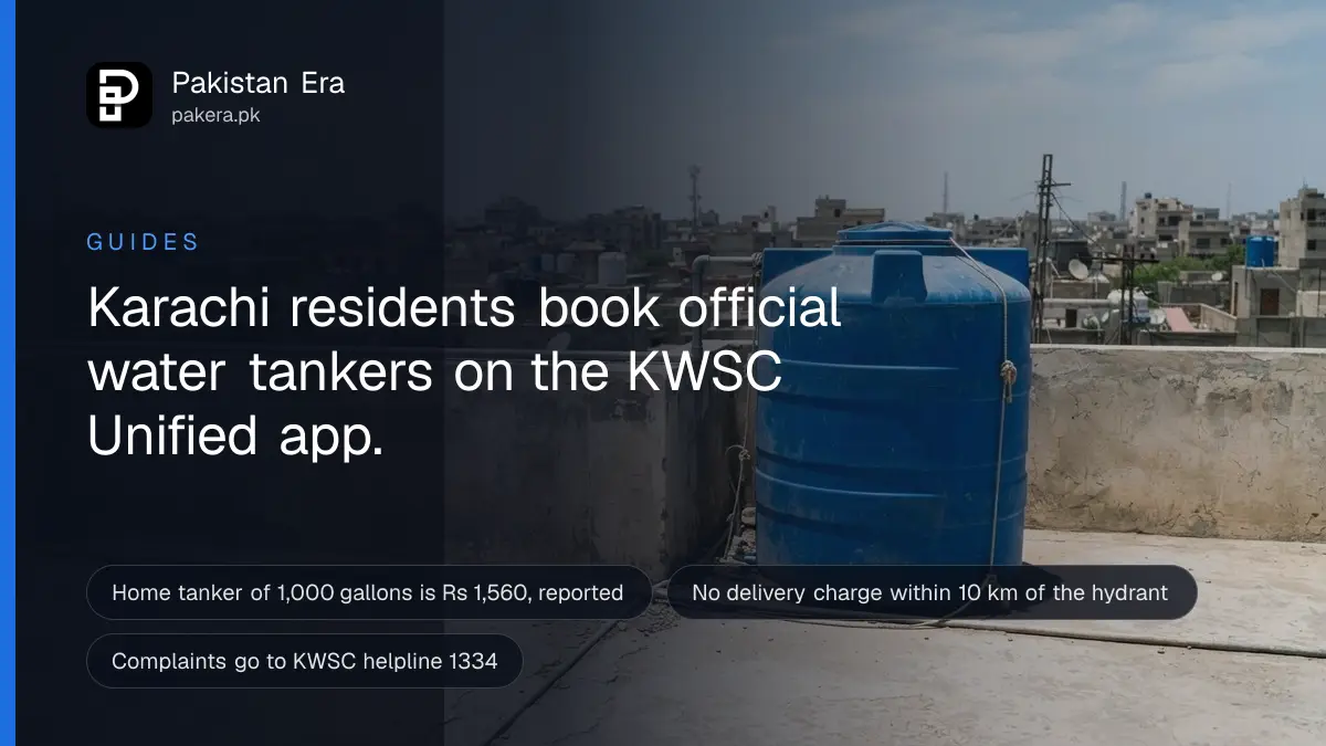 A blue plastic water tank on a flat concrete rooftop in Karachi under bright noon sun