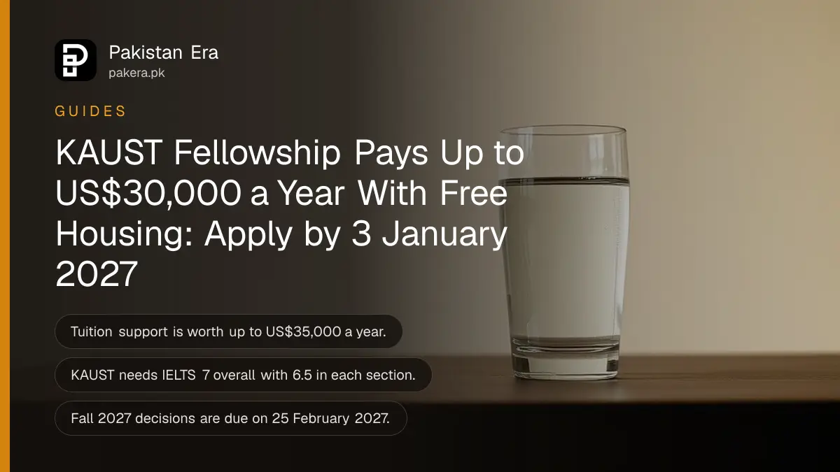 A clear glass of water on a dark wooden table against a plain cream wall in soft daylight