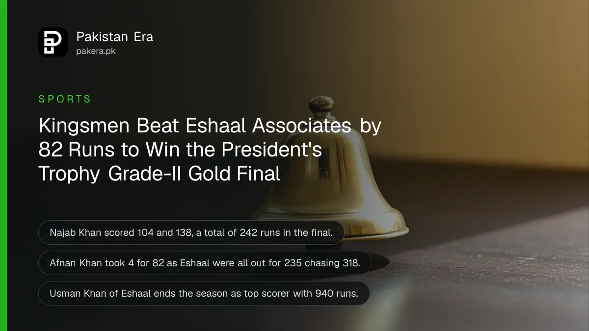 A small polished brass bell on a dark wooden table in soft daylight