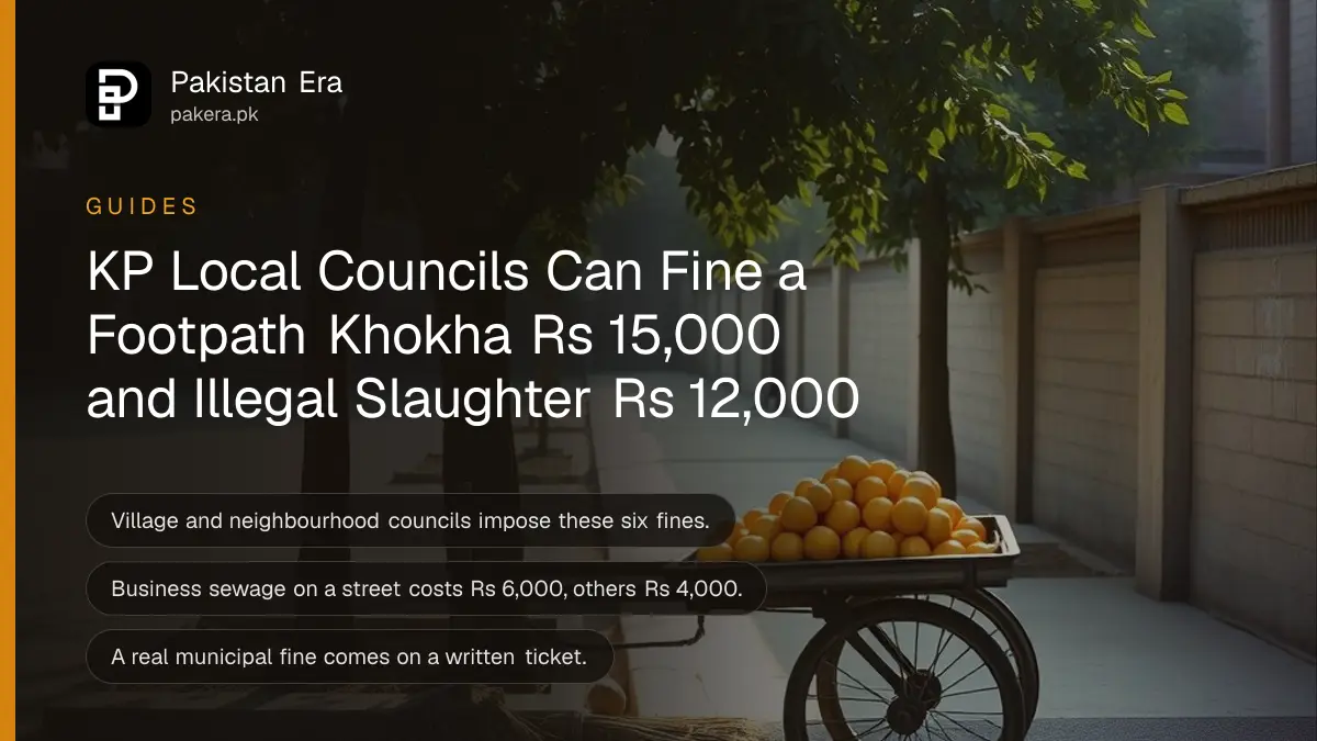 A wooden handcart loaded with oranges parked beside a swept pavement under a shady tree in soft morning light