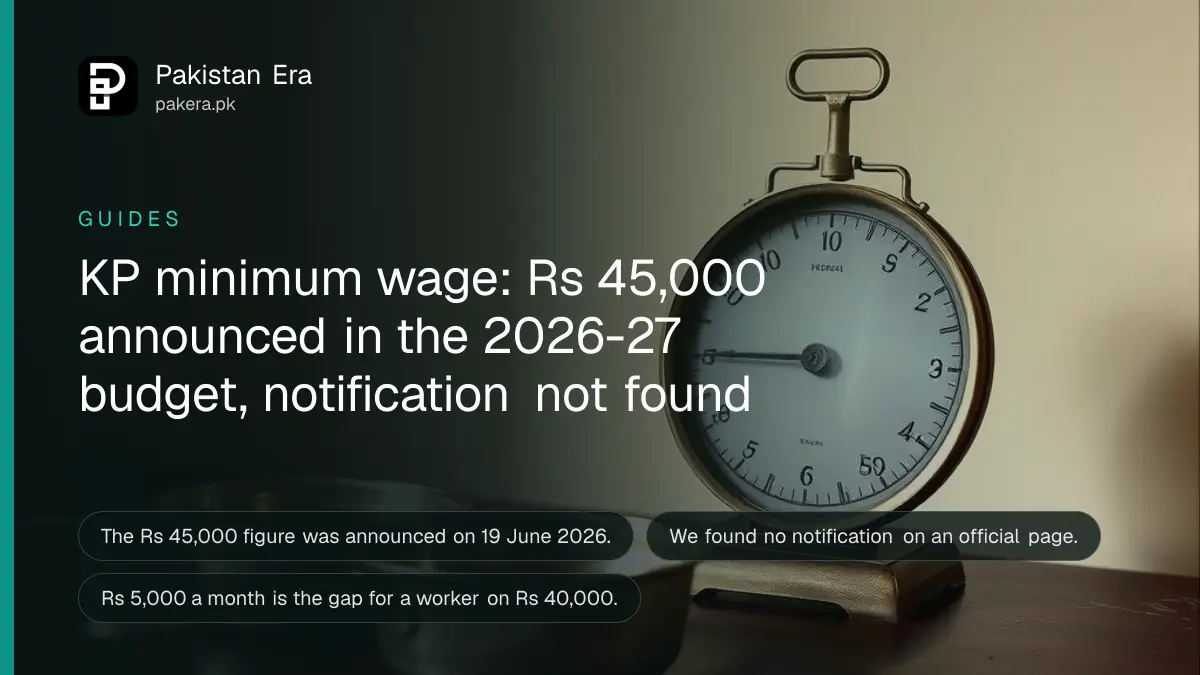 A brass weighing scale with two empty pans on a dark wooden table, for a guide on the Khyber Pakhtunkhwa minimum wage 2026-27