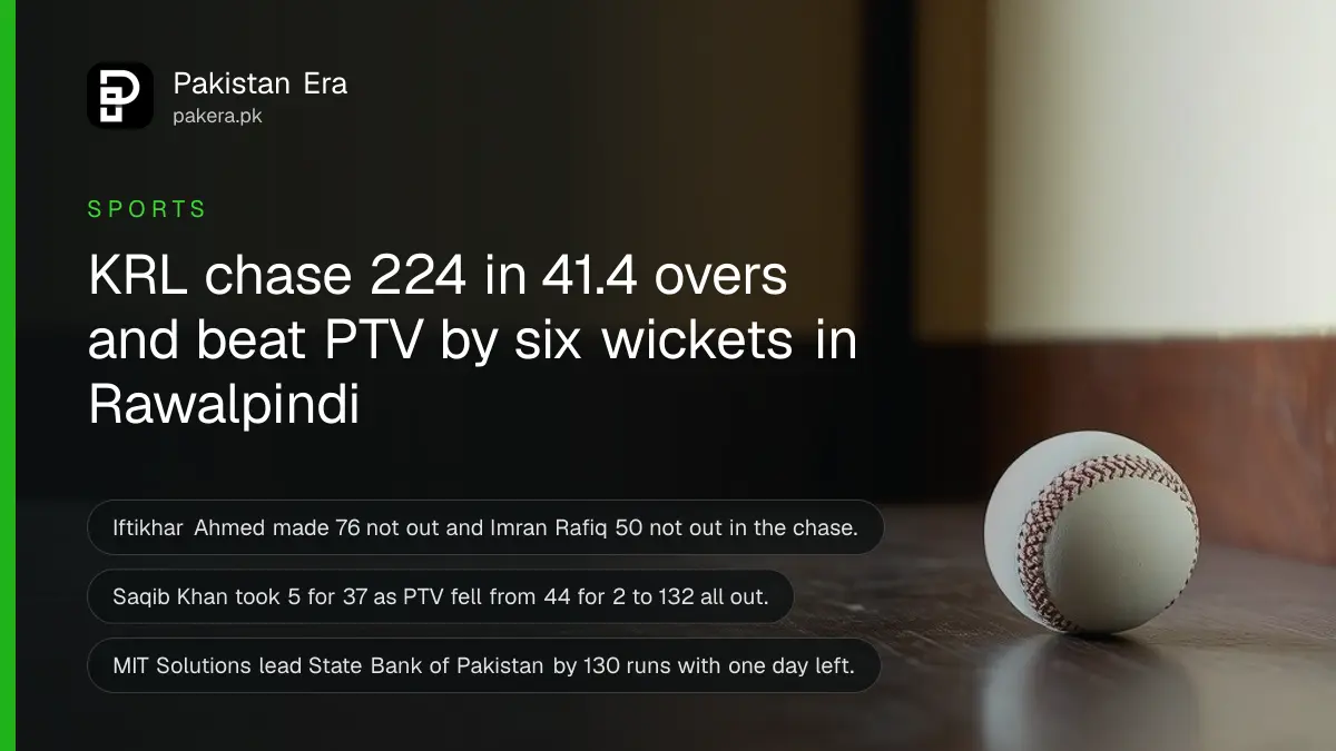 A white cricket ball resting on a dark wooden table against a plain cream wall in soft daylight