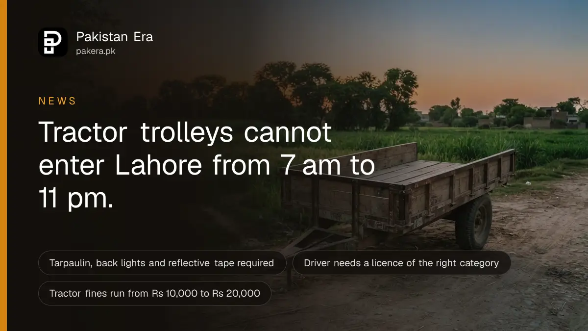 An empty tractor trolley parked at the edge of a rural road outside Lahore at dusk, fields behind it