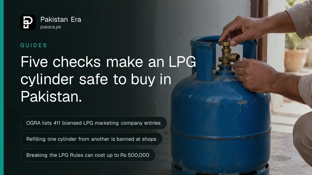 Hands checking the brass valve of a steel gas cylinder standing on a concrete floor