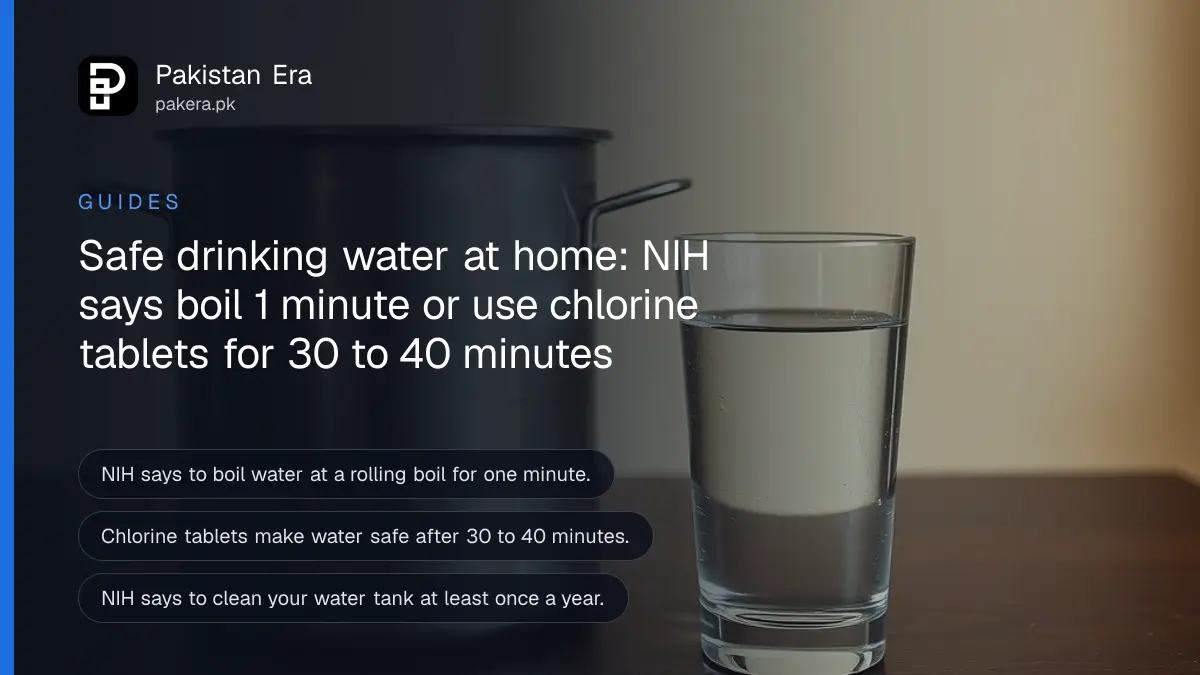 A clear water glass on a dark wooden table against a cream wall, for a guide to making drinking water safe in Pakistan