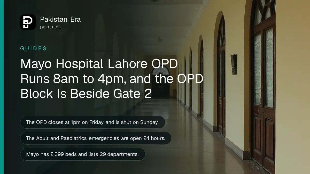 A long empty hospital corridor with cream walls, arched windows and a polished floor in soft morning light