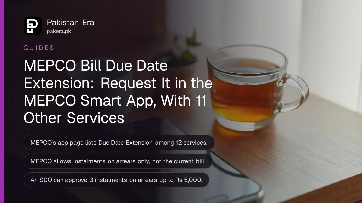A smartphone lying face up with its screen dark on a wooden desk beside a cup of tea and a small potted plant