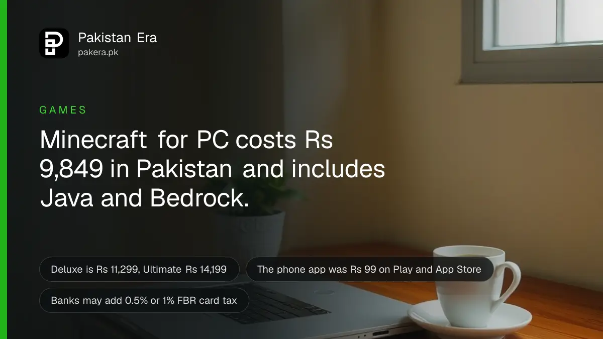 A laptop with its lid half closed on a wooden desk beside a green potted plant and a cup of tea in Islamabad