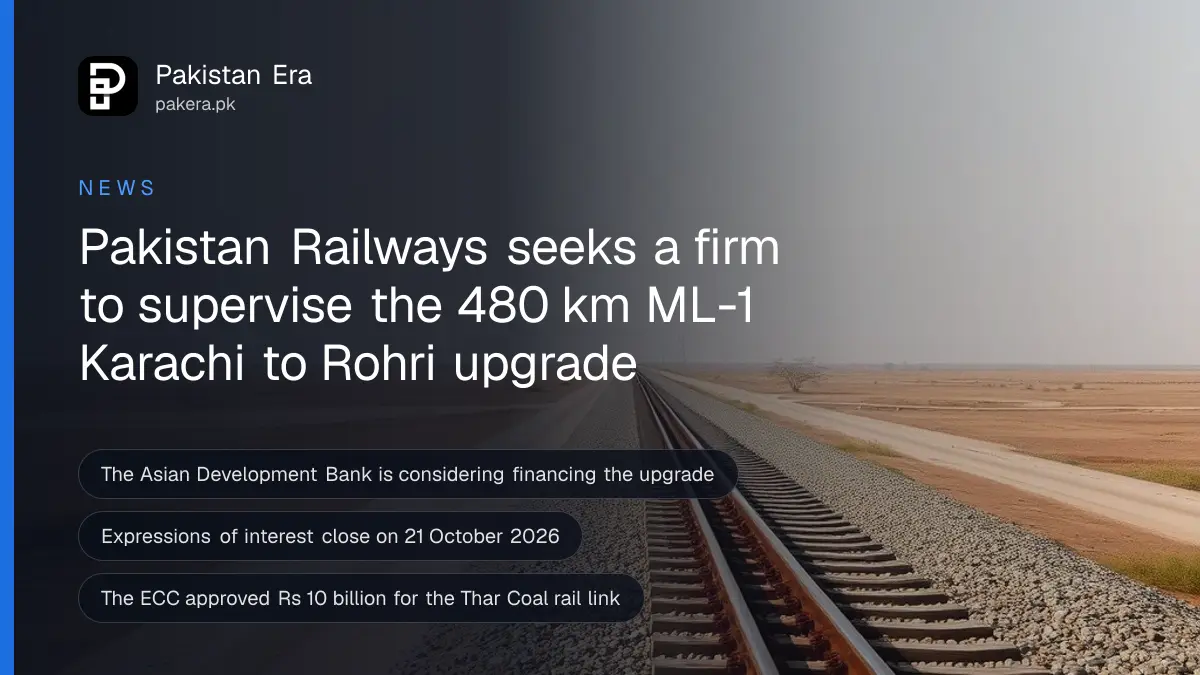 A long straight railway track running across flat dry land in Sindh towards the horizon under a pale morning sky