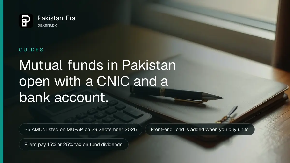 A calculator and a closed notebook on a wooden desk by a sunny window, ready for planning savings