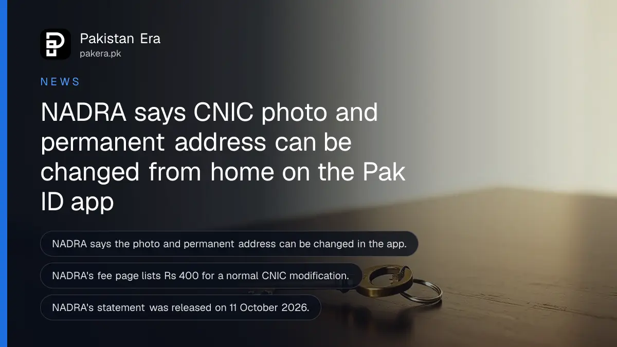A brass key on a dark wooden table, for an article on change cnic photo pak id app