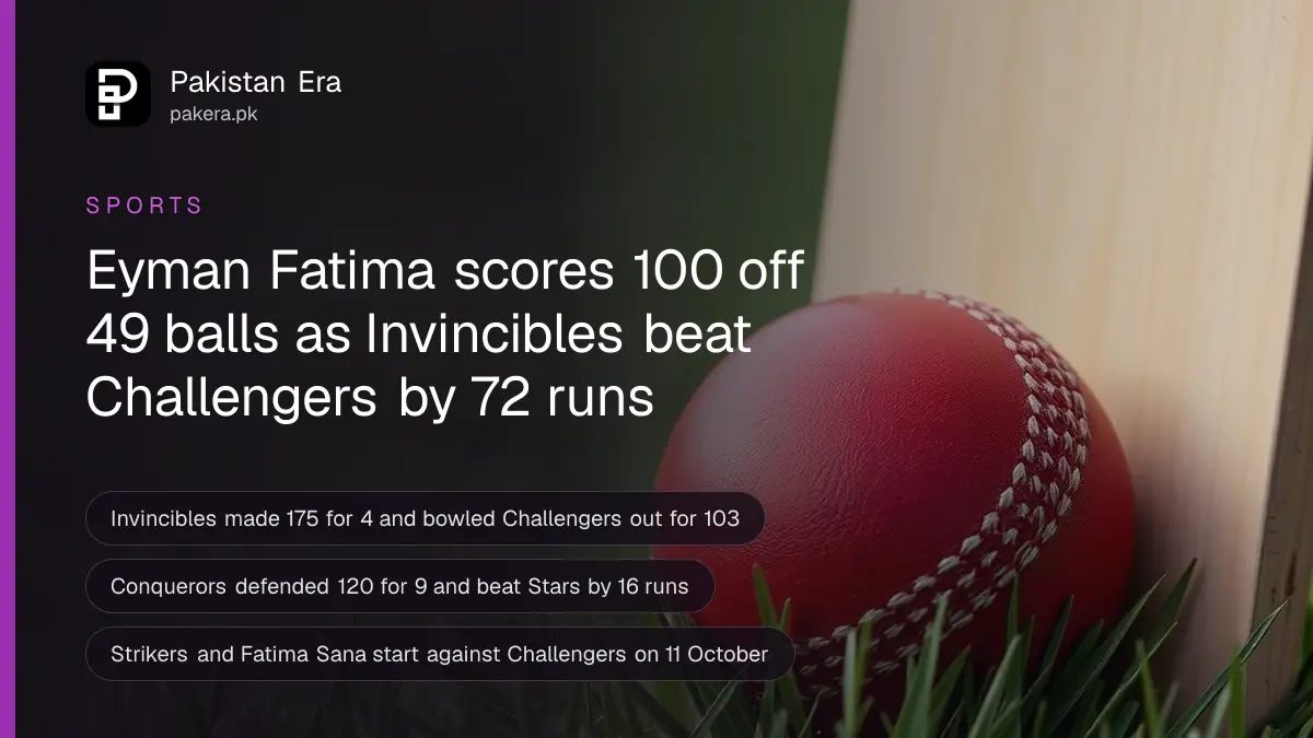 A red cricket ball and a wooden bat resting on green grass in morning light